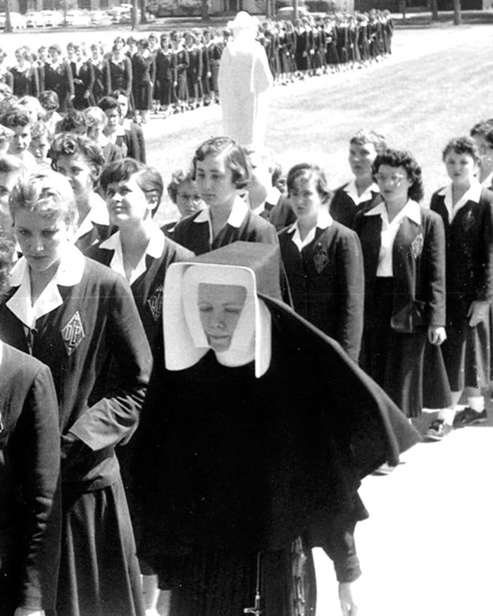 A procession on the grounds of Our Lady of Peace High School