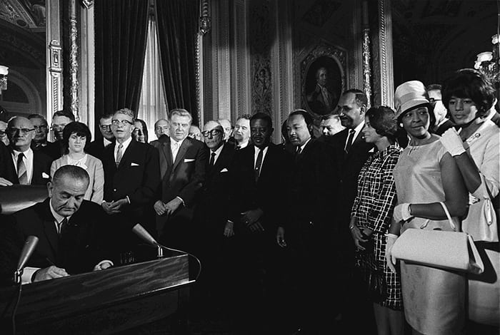 Presiden Lyndon Johnson signs the Voting Rights Act of 1965